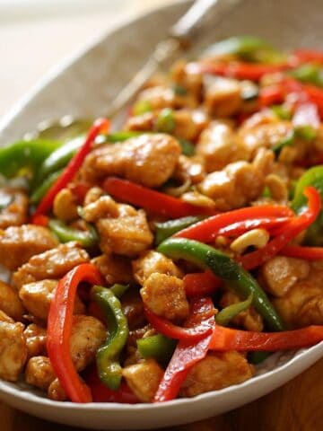 A platter of cashew chicken with peppers