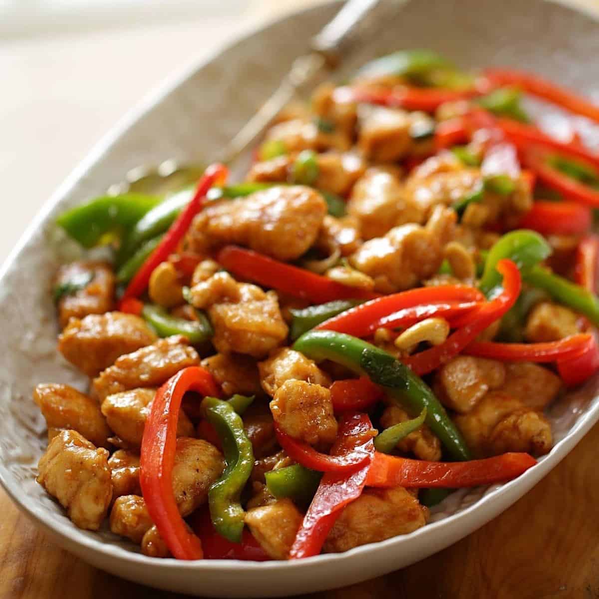 A platter of cashew chicken with peppers