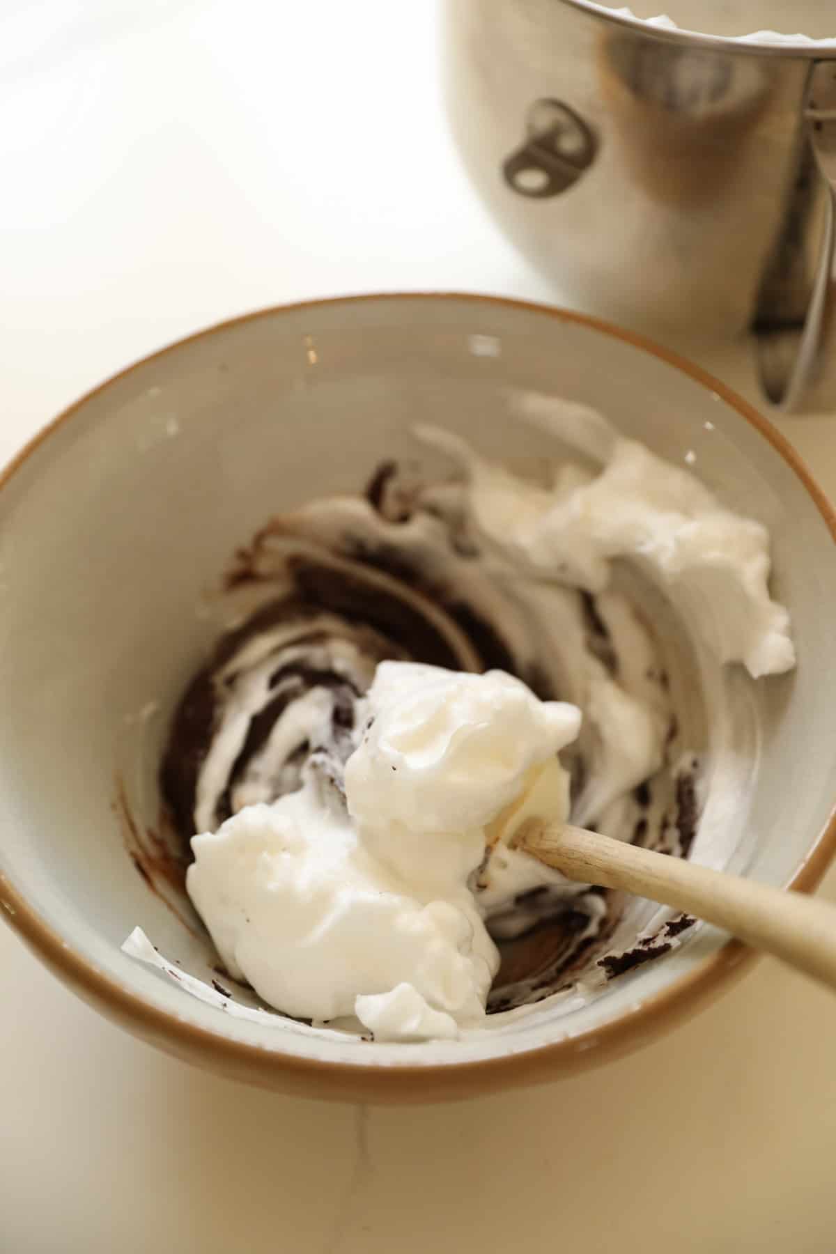 Egg whites being folded into chocolate mixture