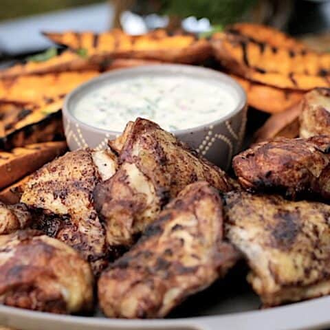a platter of grilled cinnamon chicken and sweet potatoes