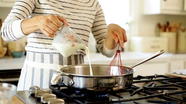 Pouring milk into a skillet