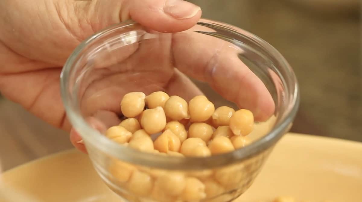 reserving a small bowl of chickpeas in a glass bowl