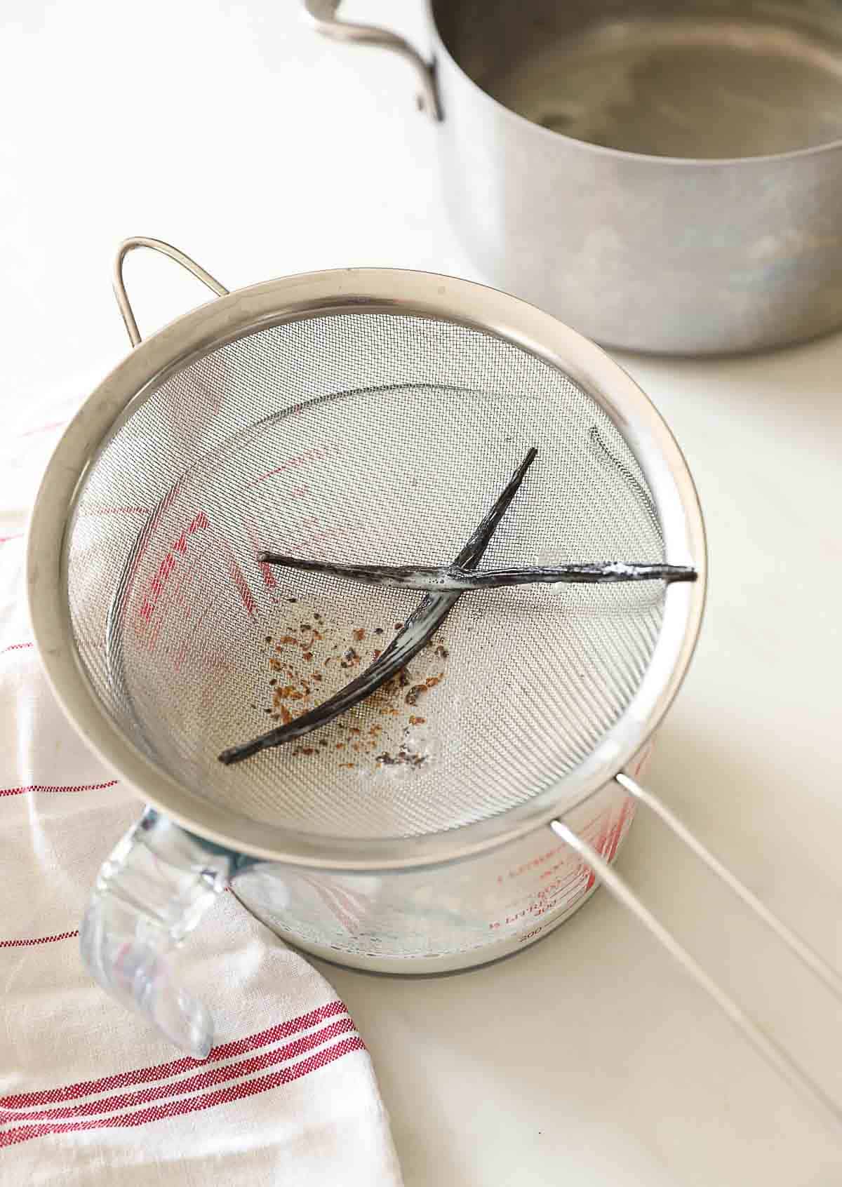 A pyrex pitcher and a fine mesh sieve over a Pyrex pitcher