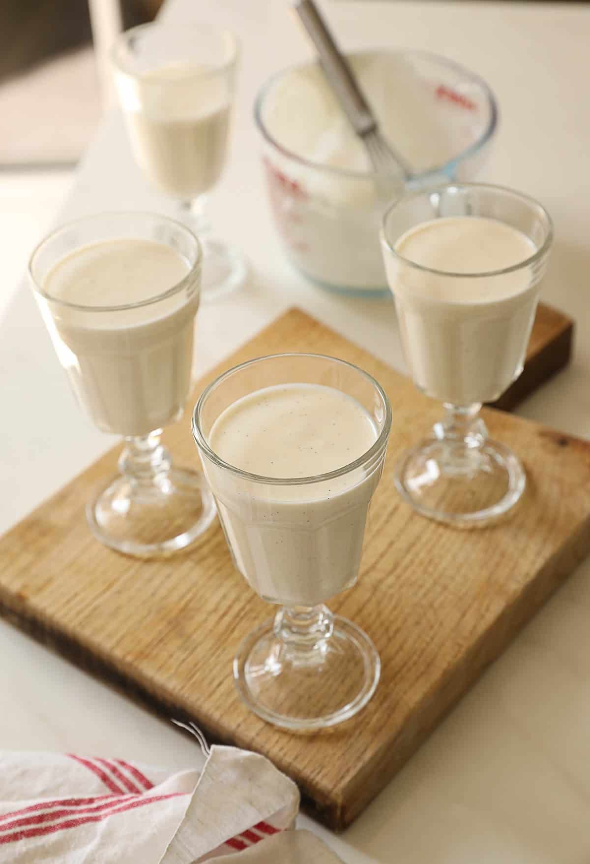 Footed glasses filled with the panna cotta mixture.