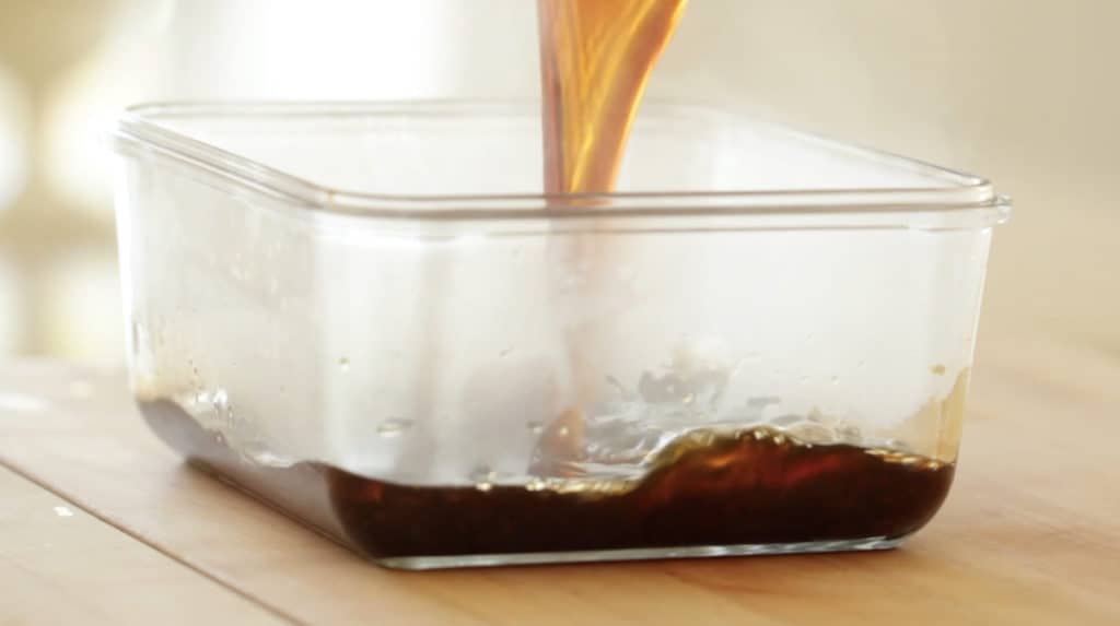 Pouring homemade Teriyaki Sauce into a container to cool