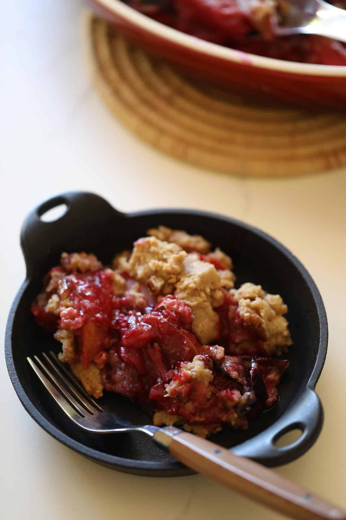 Plum Crumble served in a small cast iron dish