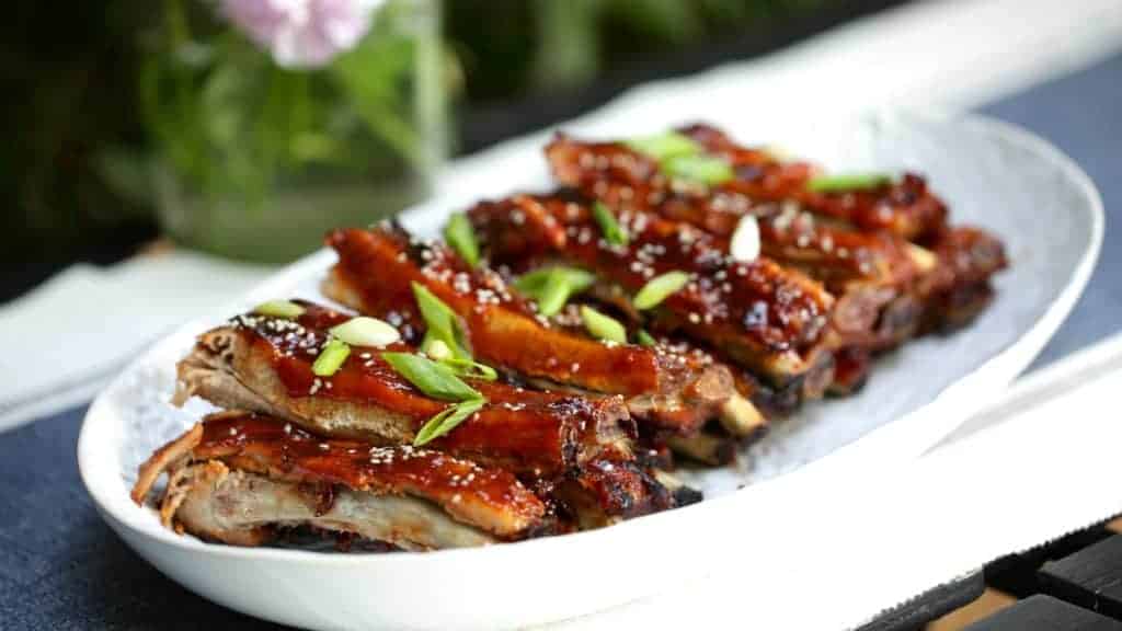 BBQ Ribs Recipe garnished on a platter and ready to be served