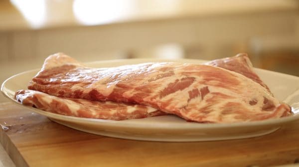 A plate of raw pork spare ribs before being turnmed into a wonderful BBQ Ribs recipe by entertaining with Beth