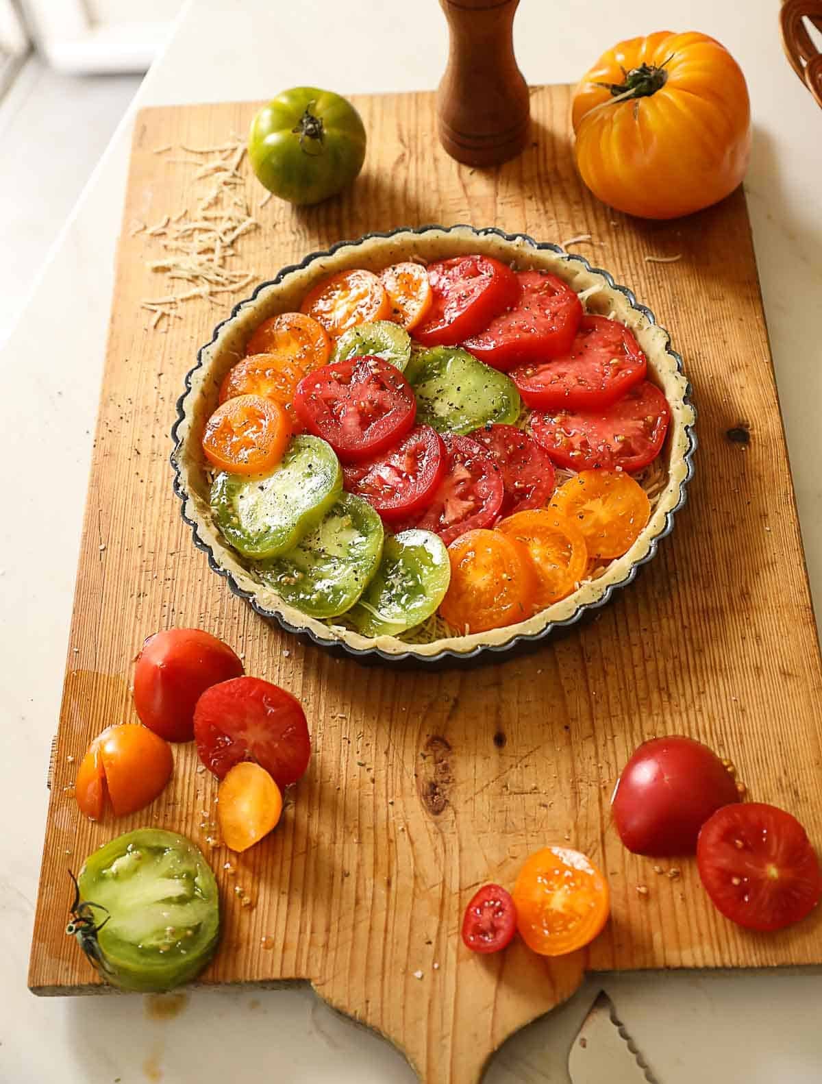 A French tomato tart fitted with tomatoes before baking.