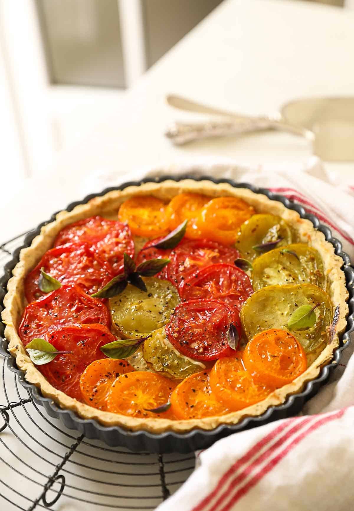 A tart with baked tomatoes cooling.