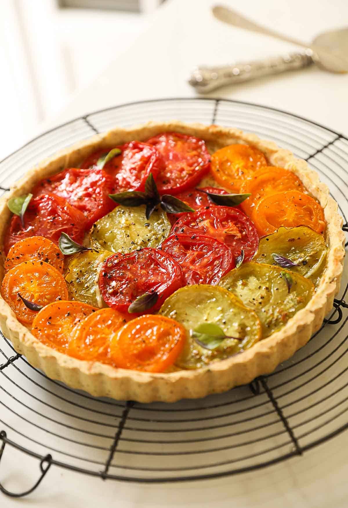 a tomato tart released from its tin and cooling.