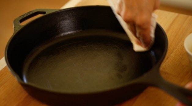 Cast-iron Skillet being greased