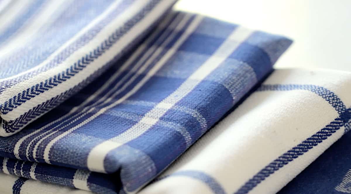 a stack of blue and white dish towels