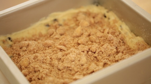 Crumb topping on cake in a silver baking pan 