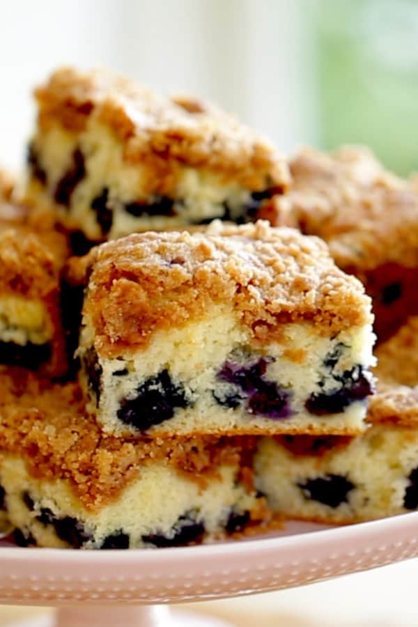 A close up of a piece of blueberry breakfast cake with crumb topping