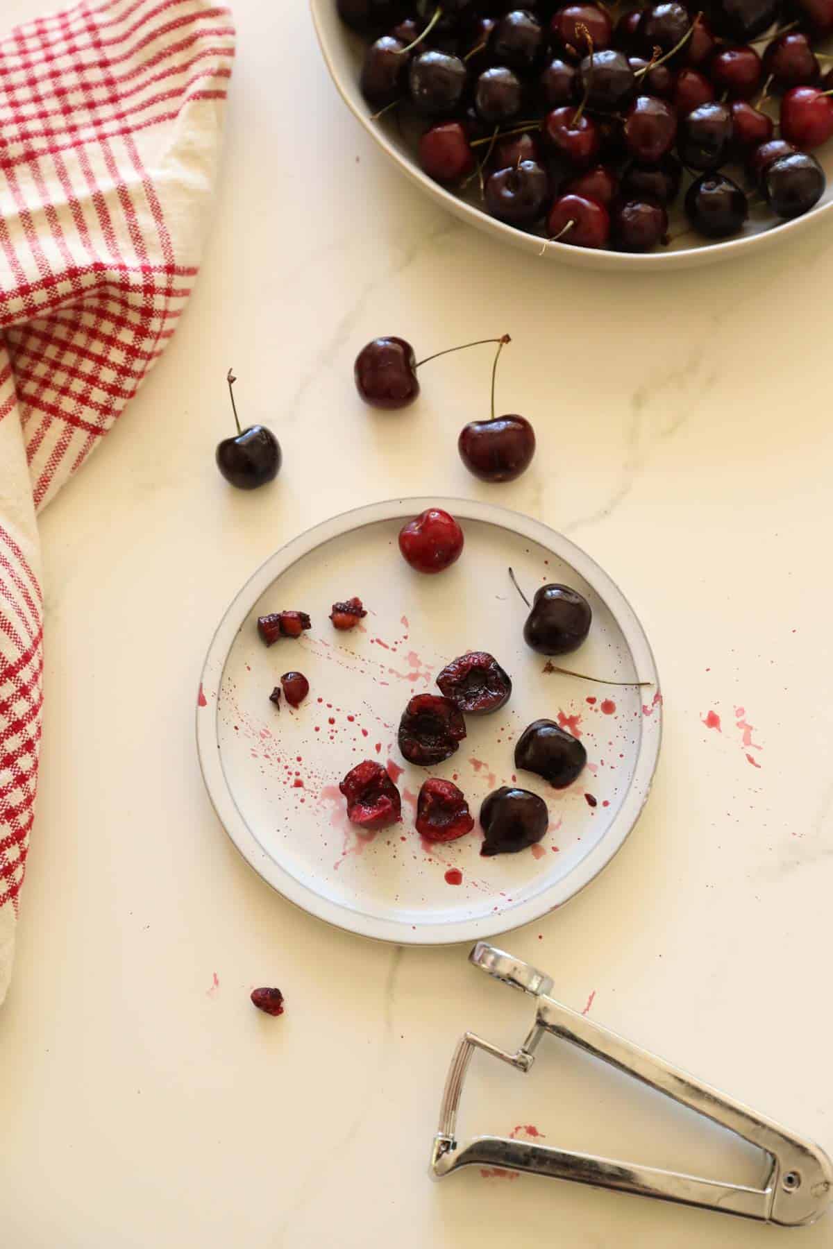 Cherries being pitted with a cherry pitter