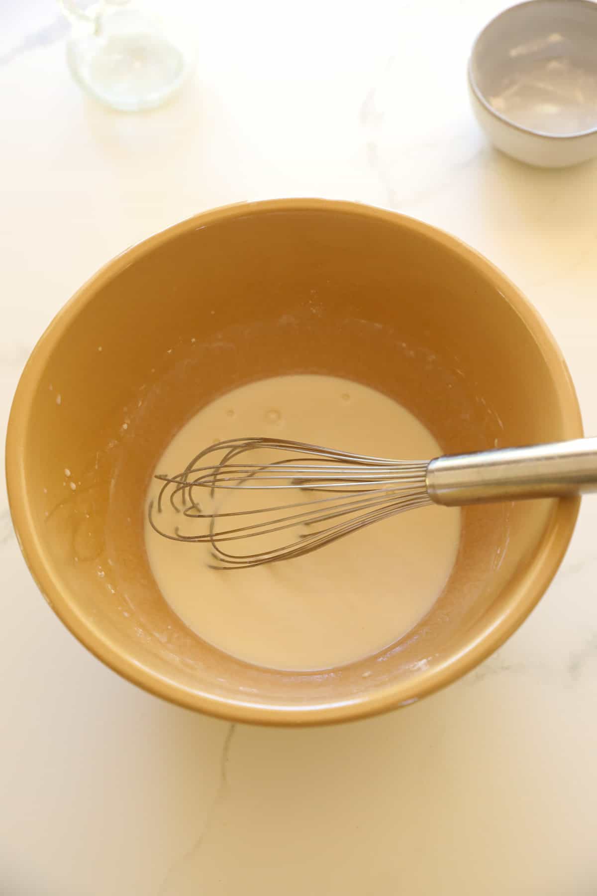 Batter in a bowl with a whisk