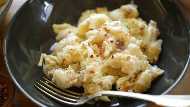 Bowl of Baked Mac and Cheese Recipe in a black bowl with a fork