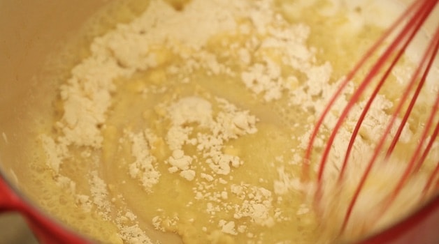Butter and flour being whisked in a pot