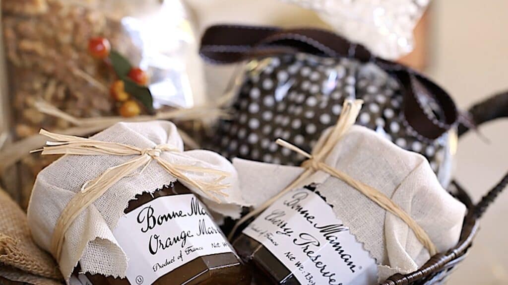 a basket of packaged pumpkin bread, jams and coffee