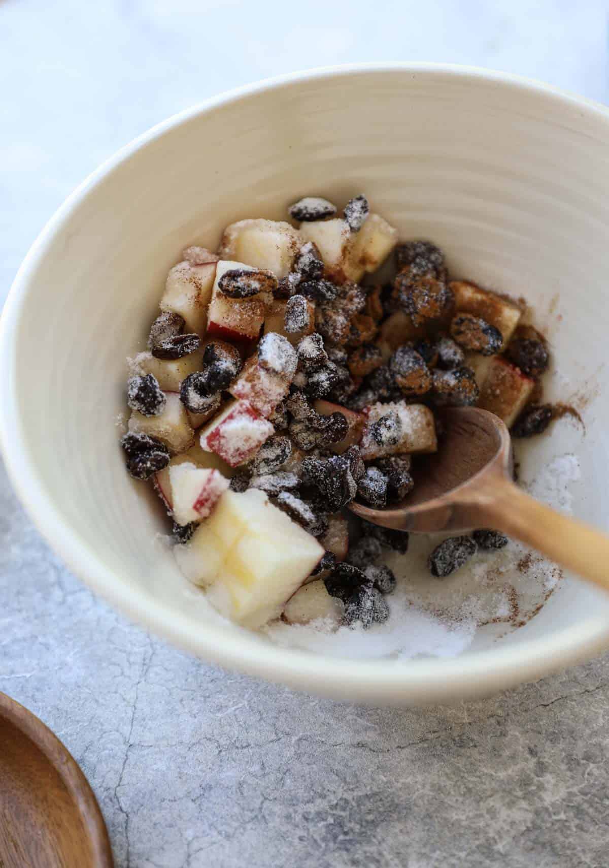 Chopped Apples, Raisins, Sugar and cinnamon in a bowl 