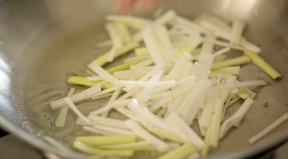 fresh raw leeks in a pan with olive oil