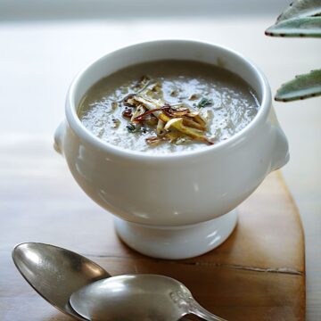 Cream of Mushroom Soup with Crispy Leeks and silver spoons