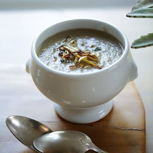 Cream of Mushroom Soup with Crispy Leeks and silver spoons