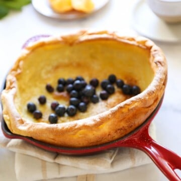 a Dutch Baby Pancake in a Red Skillet with Blueberries