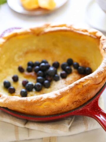 a Dutch Baby Pancake in a Red Skillet with Blueberries