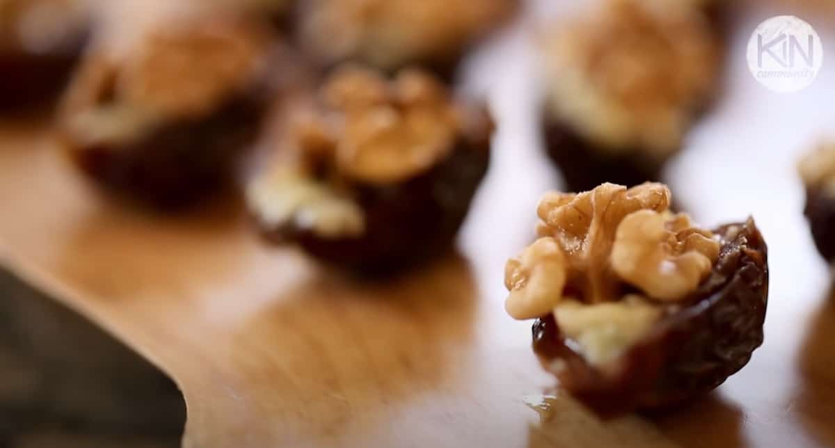 dates filled with cheese top with a raw walnut