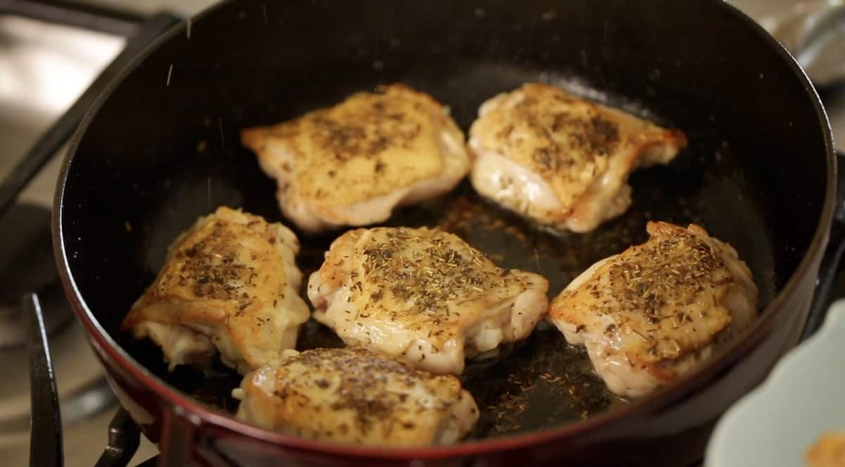 Seared Chicken thighs with crispy skin in a cast-iron braiser