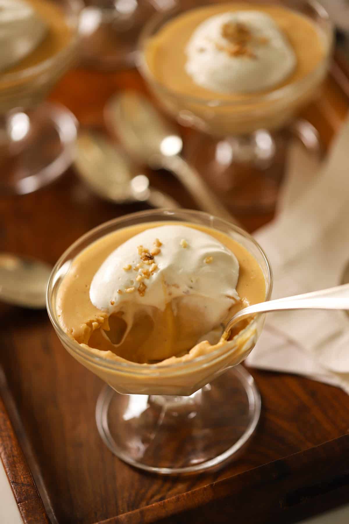 A spoon taking a bite out of pudding.