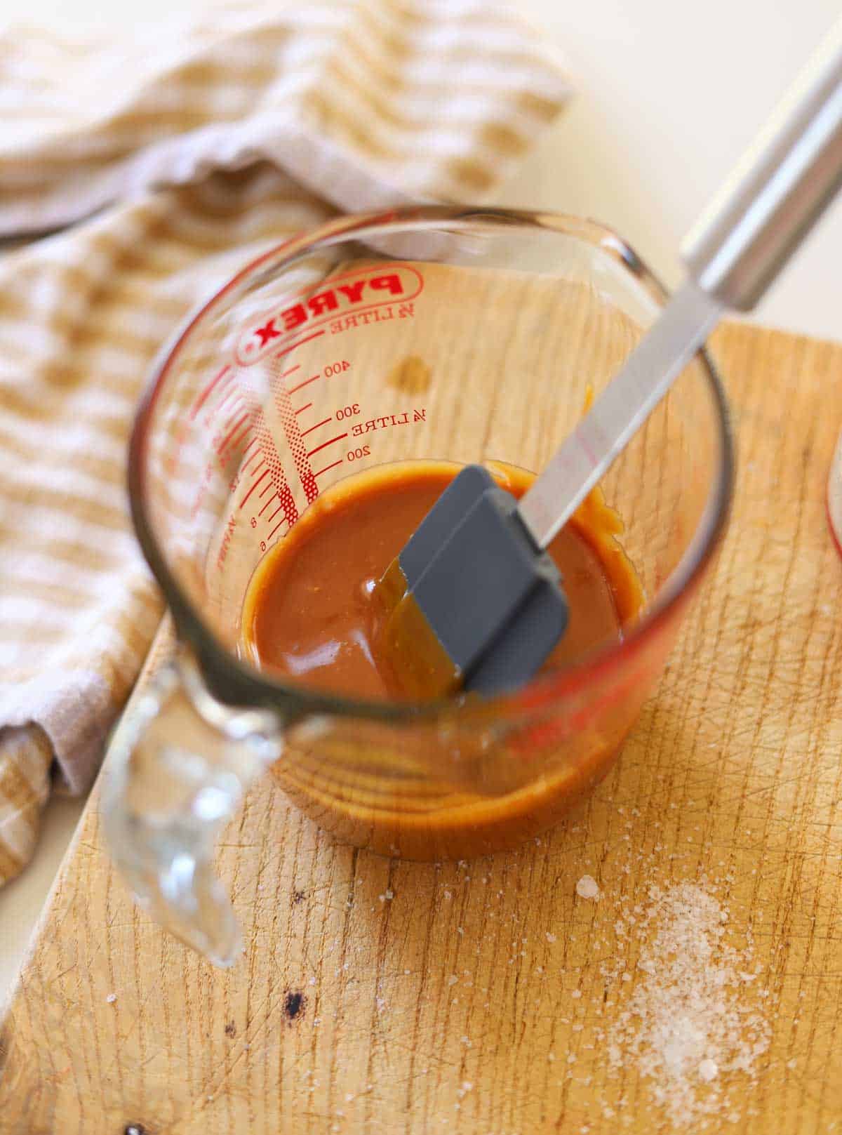 salted caramel cooling in a Pyrex pitcher.