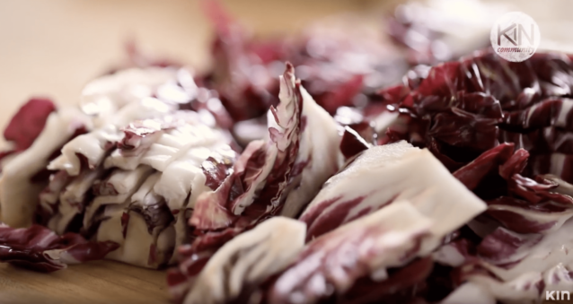 Radicchio being sliced on a cutting board