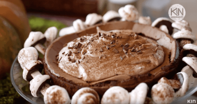 Wickedly Good Chocolate Cake with Meringue Mushrooms on a cake stand