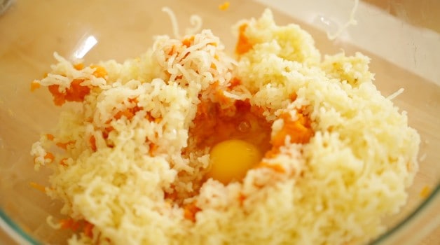 Egg well in gnocchi ingredients in large mixing bowl