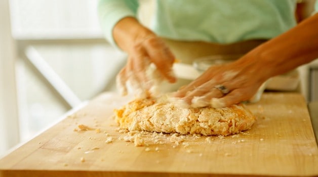 Shaping gnocchi dough on a floured cutting board