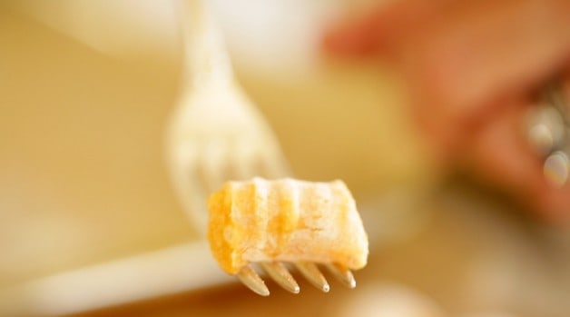 freshly shaped raw gnocchi on a fork