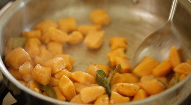 Sauteeing Sweet Potato Gnocchi in a pan with butter and sage leaves