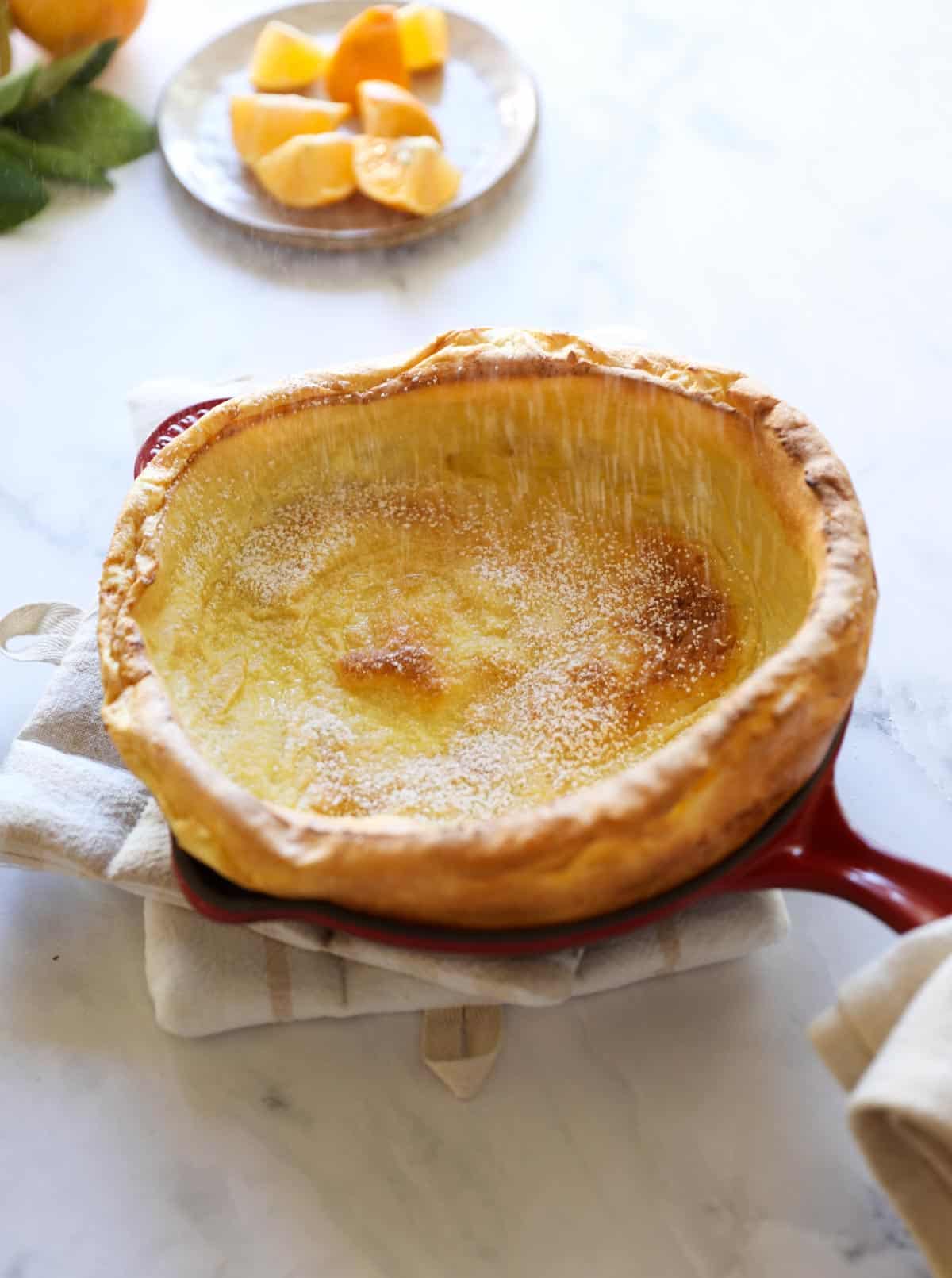 a Dutch Baby pancake in a red skillet