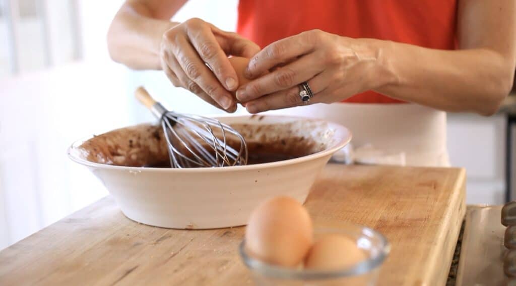 Cracking Eggs into a bowl of chocolate