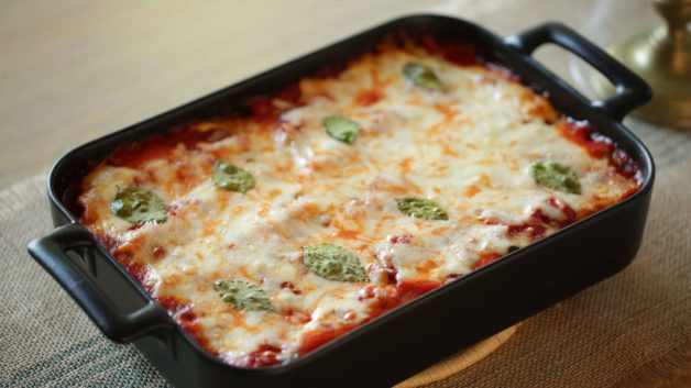 A freshly baked casserole of a Veggie Lasagna Roll-Ups ready to be served