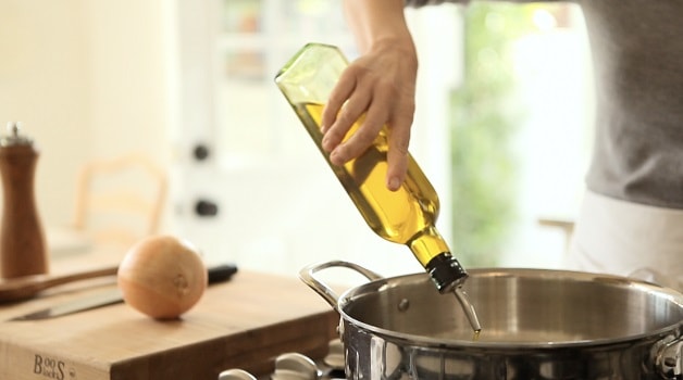 Adding olive oil to pan