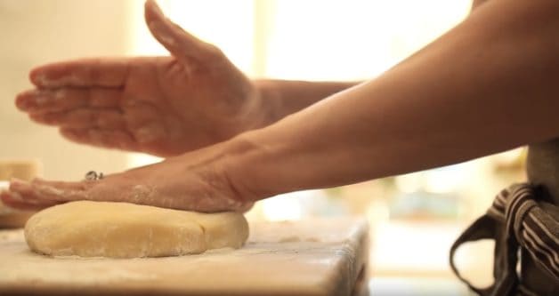 Pressing down tart dough on a floured cutting board