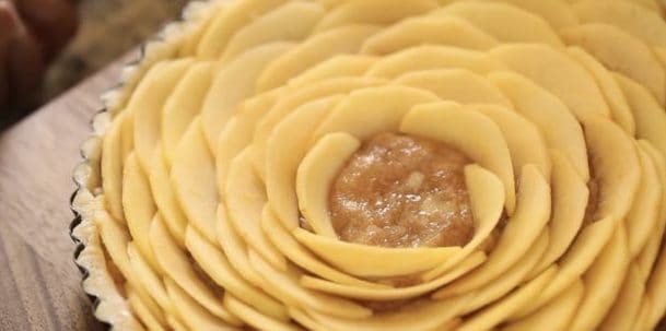 Apple Slices arranged in an escargot pattern leaving a small circle in the top of the tart for decorative rose