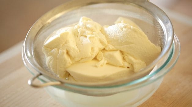 Ricotta Cheese draining in a glass bowl