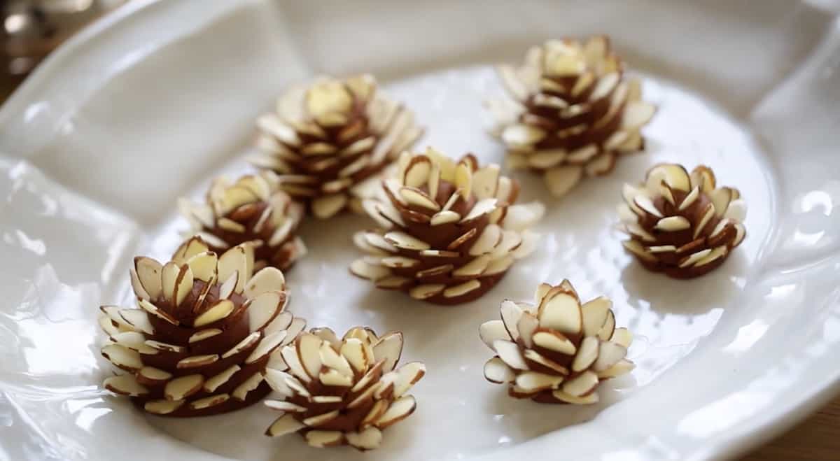 Fndant Pinecones for decorating yule log on a white plate