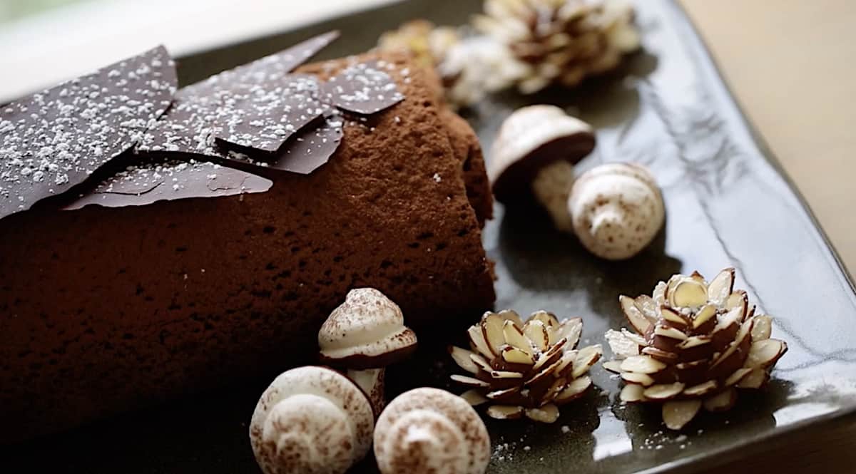 Buche de noel decorations at the corner of a platter