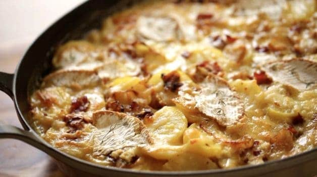 Tight shot of a freshly bakedTartiflette in a gratin pan